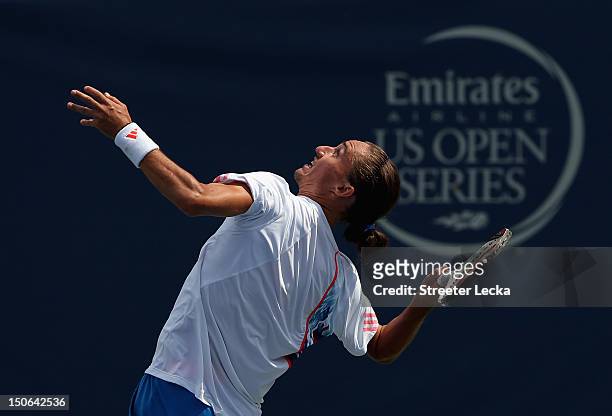 Alexandr Dolgopolov of Ukraine serves to Sam Querrey of the USA during the quarterfinals of the Winston-Salem Open at Wake Forest University on...