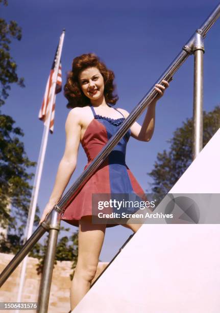American actyress Susan Hayward by an American flag, circa 1946.