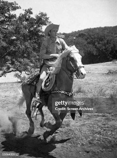 American actor Roy Rogers riding Trigger galloping on his horse, Trigger in a western movie, circa 1948.