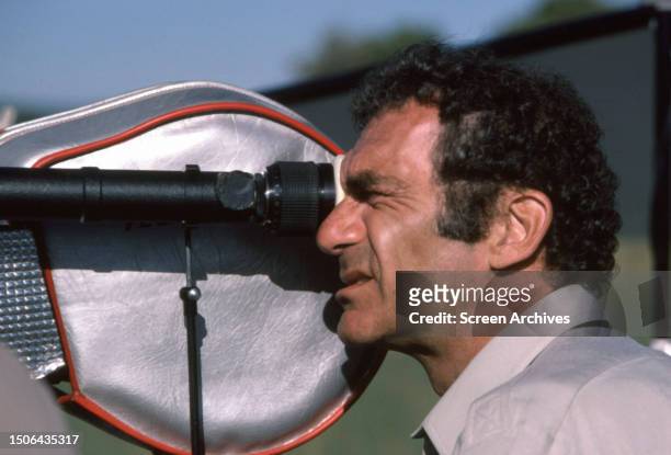 American film director, producer and actor Sidney Pollack loking through a viewfinder
