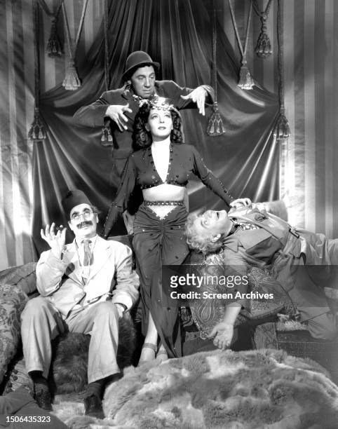 The Marx Brothers Groucho, Chico and Harpo with Lisette Verea in a promotional portrait for 'A Night in Casablanca', 1946. .