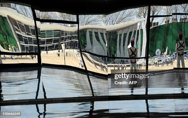 The image of the Brazilian Supreme Court building, where the trial known as 'mensalao' is being held, is seen reflected on a mirror wall inside the...