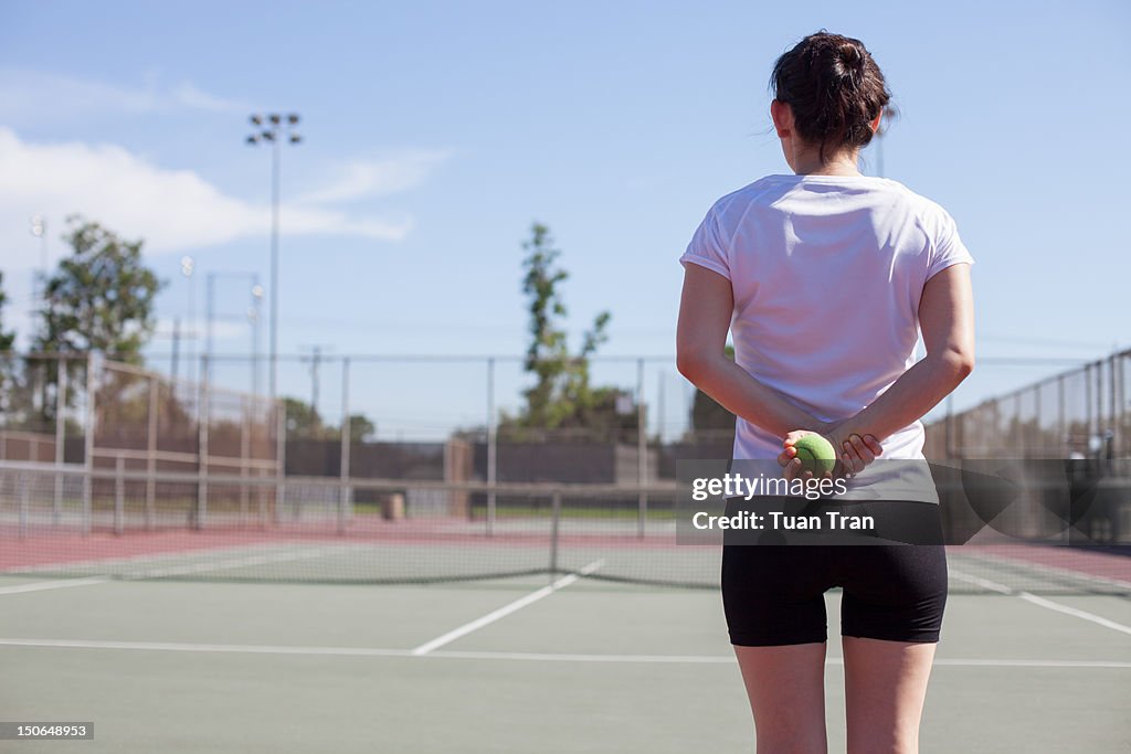 Woman holding tennis ball