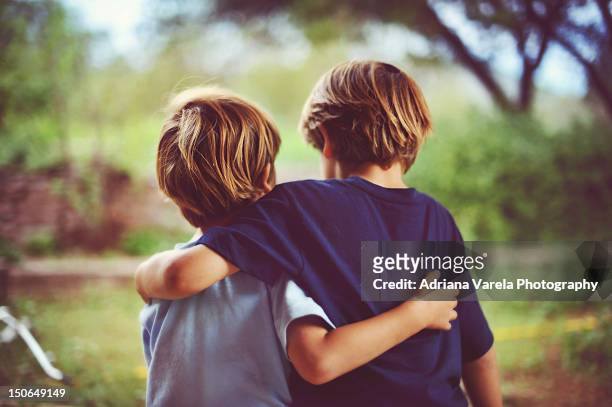 brothers - brothers boys cuddle stock pictures, royalty-free photos & images