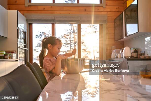 asian girl 6 years old prepares a delicious cake. - showing kindness stock pictures, royalty-free photos & images