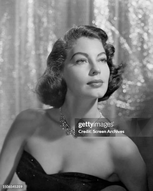 American actress Ava Gardner wearing an off-shoulder dress and a diamond necklace circa 1950.