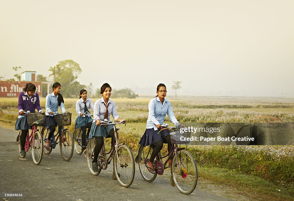 Young girls going to school on their bicycle