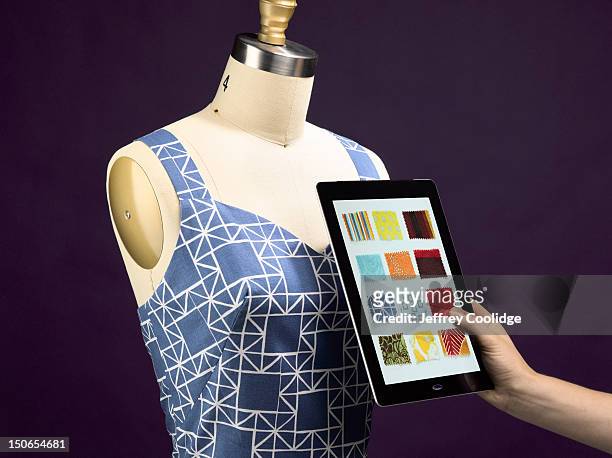 cloth swatches on digital tablet with sewing form - touching fabric stock pictures, royalty-free photos & images