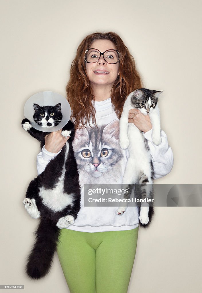 Woman holding two cats