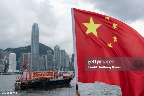 Fishing boats fly Chinese and Hong Kong flags during a parade at the Victoria Harbour on July 01, 2023 in Hong Kong, China. Hong Kong is marking the...