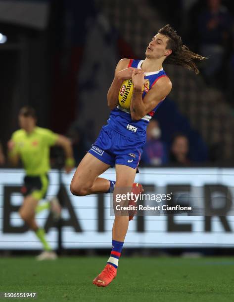 Caleb Pulter of the Bulldogs controls the ball during the round 16 AFL match between Western Bulldogs and Fremantle Dockers at Marvel Stadium, on...