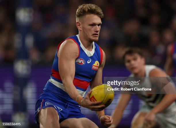 Adam Treloar of the Bulldogs runs with the ballduring the round 16 AFL match between Western Bulldogs and Fremantle Dockers at Marvel Stadium, on...