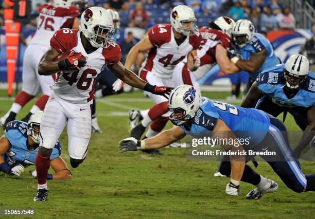 Scott Solomon of the Tennessee Titans dives for Alfonso Smith of the Arizona Cardinals at LP Field on August 23, 2012 in Nashville, Tennessee.