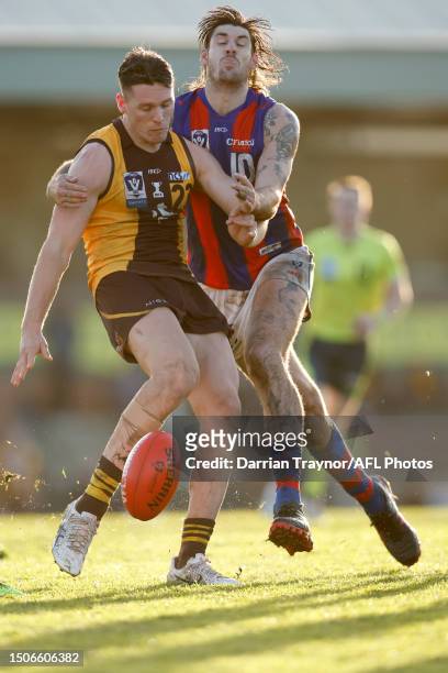 Sam Naismith of Port Melbourne tackles Jacob Koschitzke of Box Hill as he kicks the ball during the VFL round 15 match between Box Hill and Port...