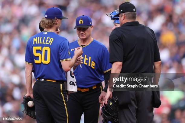 Bryce Miller of the Seattle Mariners reacts to a possible injury with manager Scott Servais against the Tampa Bay Rays during the third inning at...