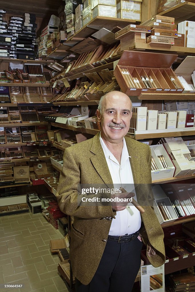 Portrait of a happy standing in front of cigar display