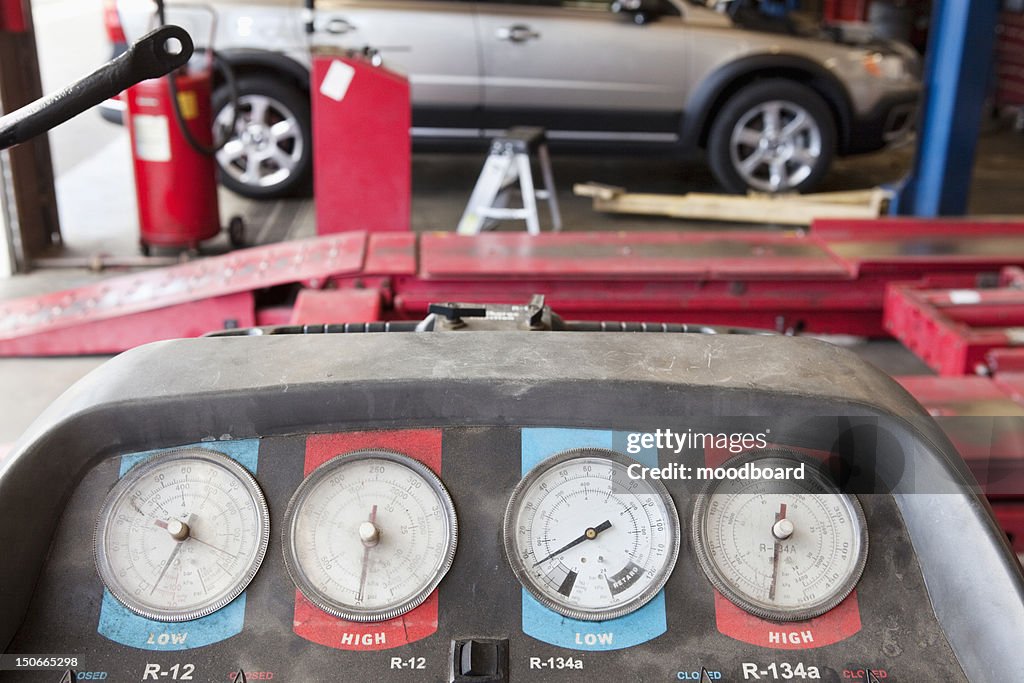 Close-up of a hoist pressure gauge in garage