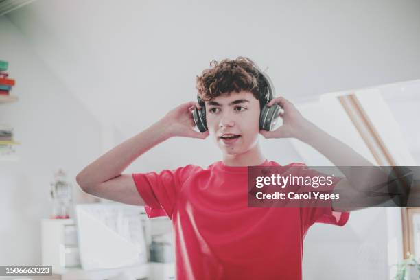 boy listening music with headphones at home - funky boy stock pictures, royalty-free photos & images