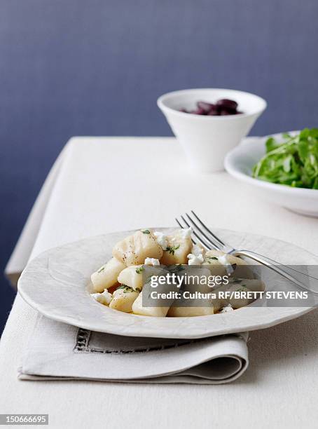 plate of gnocchi with olives - kalamata olive stock-fotos und bilder