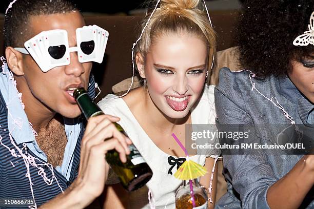 friends sitting together at party - beer bottle mouth stock pictures, royalty-free photos & images