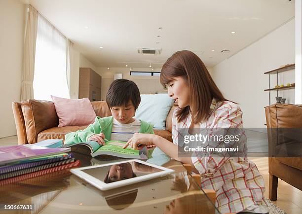 mother and son studying in a living room - japanese people lesson english stock pictures, royalty-free photos & images