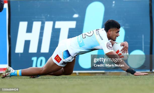 Nolan Stringer Alofiana Khan-Pereira of the Titans scores during the round 18 NRL ...