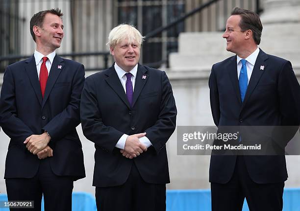 Prime Minister David Cameron stands with London Mayor Boris Johnson and Culture Secretary Jeremy Hunt as the Olympic cauldron is lit for the...