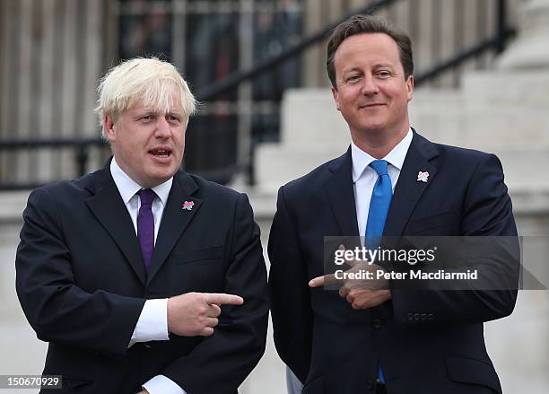 Prime Minister David Cameron stands with London Mayor Boris Johnson as the Olympic cauldron is lit for the Paralympic Games in Trafalgar Square on...