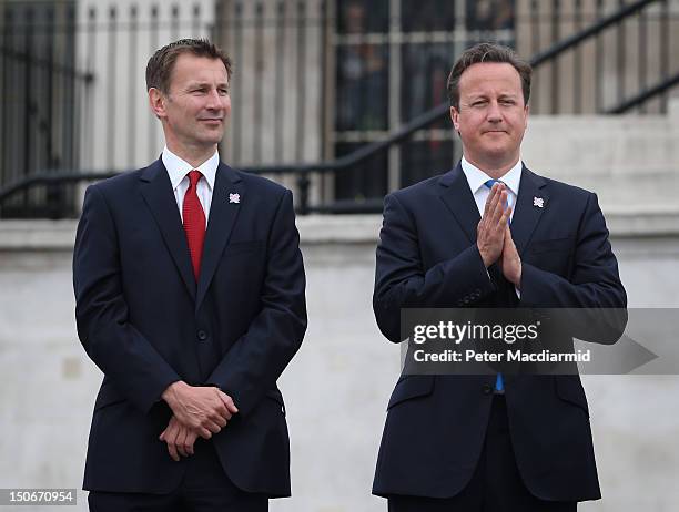 Prime Minister David Cameron stands with Culture Secretary Jeremy Hunt as the Olympic cauldron is lit for the Paralympic Games in Trafalgar Square on...