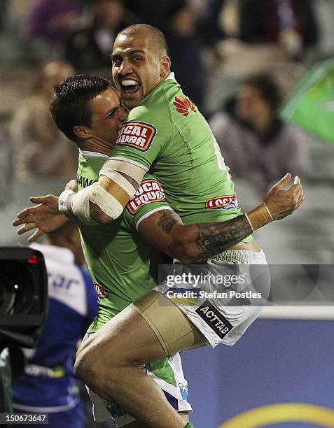 Blake Ferguson congratulates Sandor Earl of the Raiders after he scored a try during the round 25 NRL match between the Canberra Raiders and the...