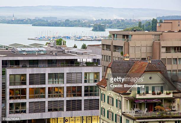 Lake Zug is seen beyond the building that houses the headquarters of Xstrata Plc, left, in Zug, Switzerland, on Friday, Aug. 24, 2012. Glencore's...