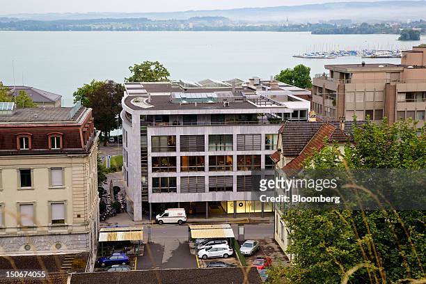 Lake Zug is seen beyond the building that houses the headquarters of Xstrata Plc, center, in Zug, Switzerland, on Friday, Aug. 24, 2012. Glencore's...