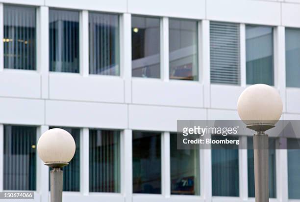 Street lights stand in front of office windows at the headquarters of Glencore International Plc in Baar, Switzerland, on Friday, Aug. 24, 2012....