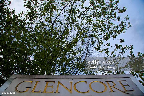 The Glencore International Plc logo sits on a sign outside the company's headquarters in Baar, Switzerland, on Friday, Aug. 24, 2012. Glencore's...