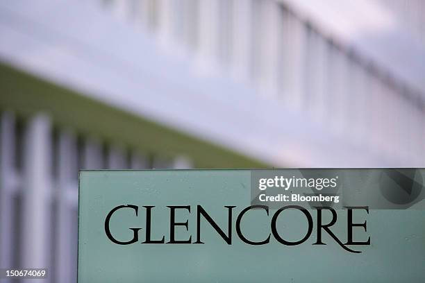 The Glencore International Plc logo sits on a sign outside the company's headquarters in Baar, Switzerland, on Friday, Aug. 24, 2012. Glencore's...