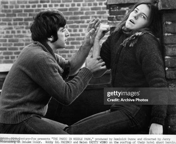 Al Pacino and Kitty Winn on the rooftop of their hotel shooting heroin in a scene from the film 'The Panic In Needle Park', 1971.