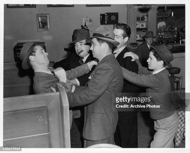 Jackie Cooper and Gene Reynolds clash with the gangsters in a scene from the film 'Gallant Sons', 1940.