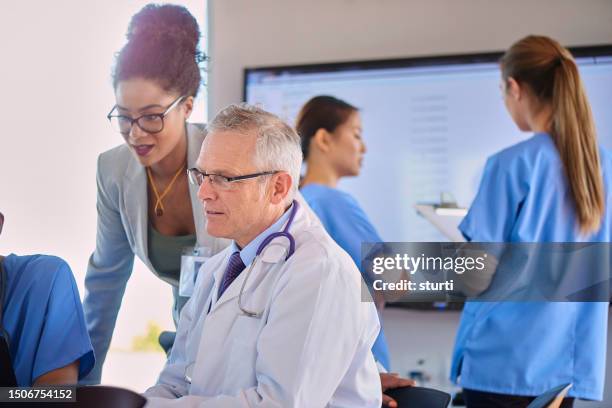 doctor chatting with administrator - sales occupation stock pictures, royalty-free photos & images