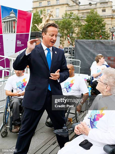 British Prime Minister David Cameron meets with flame ambassadors after the Olympic cauldron was lit for the Paralympic Games in Trafalgar Square on...