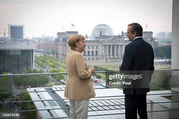 In this photo provided by the German Government Press Office , German Chancellor Angela Merkel and Greek Prime Minister Antonis Samaras talk at the...