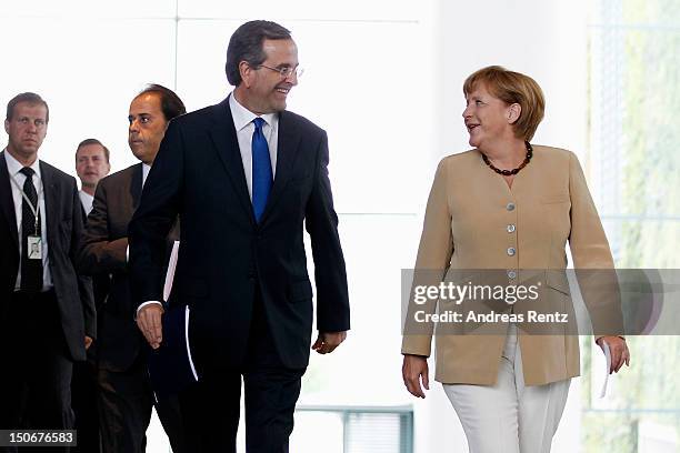 German Chancellor Angela Merkel and Greek Prime Minister Antonis Samaras arrive for a press statement at the Chancellery on August 24, 2012 in...