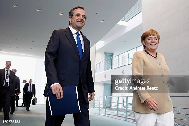 German Chancellor Angela Merkel and Greek Prime Minister Antonis Samaras arrive for a press statement at the Chancellery on August 24, 2012 in...