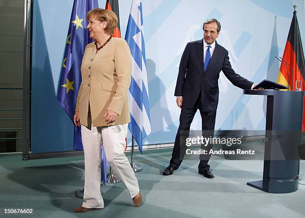 German Chancellor Angela Merkel and Greek Prime Minister Antonis Samaras leave after a press statement at the Chancellery on August 24, 2012 in...