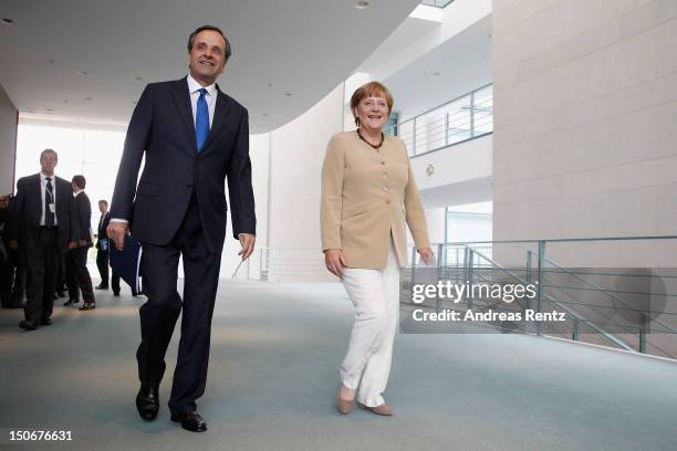 German Chancellor Angela Merkel and Greek Prime Minister Antonis Samaras arrive for a press statement at the Chancellery on August 24, 2012 in...