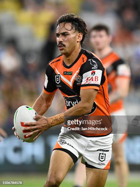 Daine Laurie of the Tigers runs the ball during the round 18 NRL match between North Queensland Cowboys and Wests Tigers at Qld Country Bank Stadium...