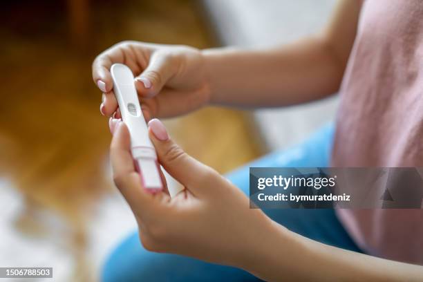 woman holding pregnancy test - gynecological examination stock pictures, royalty-free photos & images