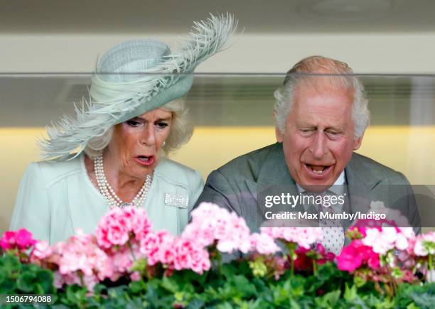 Queen Camilla and King Charles III cheer their horse 'Desert Hero' to victory in 'The King George V Stakes' as they attend day 3 'Ladies Day' of...