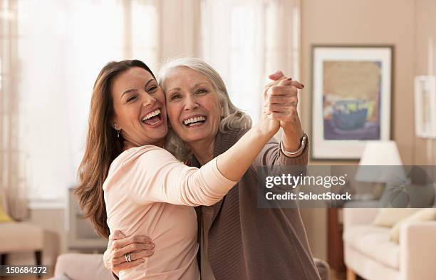 mother and daughter dancing - celebrate living stockfoto's en -beelden