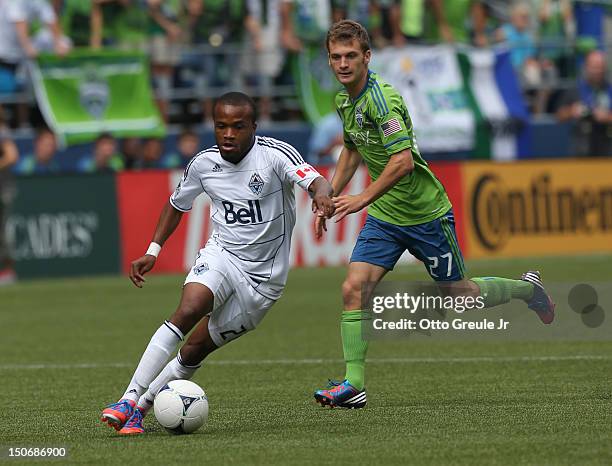 Dane Richards of the Vancouver Whitecaps dribbles against the Seattle Sounders FC at CenturyLink Field on August 18, 2012 in Seattle, Washington.