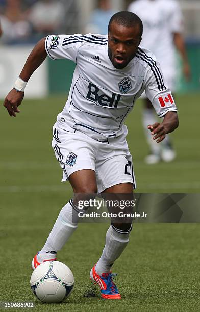 Dane Richards of the Vancouver Whitecaps dribbles against the Seattle Sounders FC at CenturyLink Field on August 18, 2012 in Seattle, Washington.